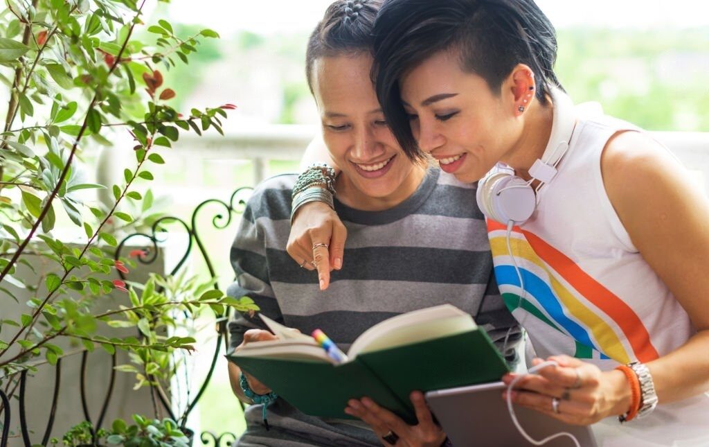 lesbian couple reading a book